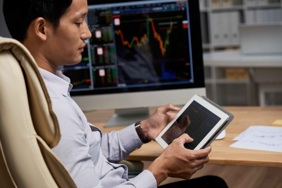 Person using their tablet to manage their stock portfolio effectively